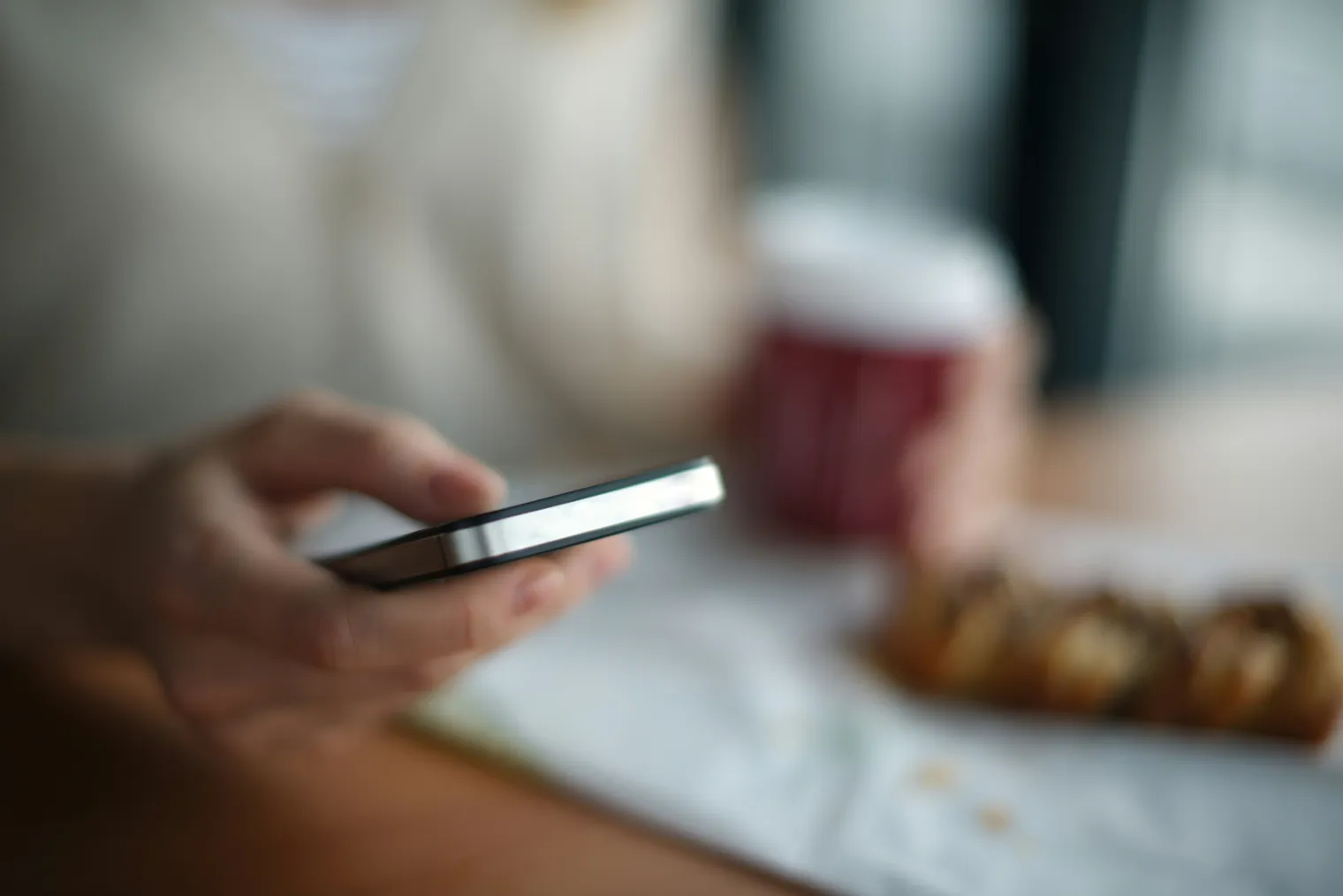A person checking their phone at a table