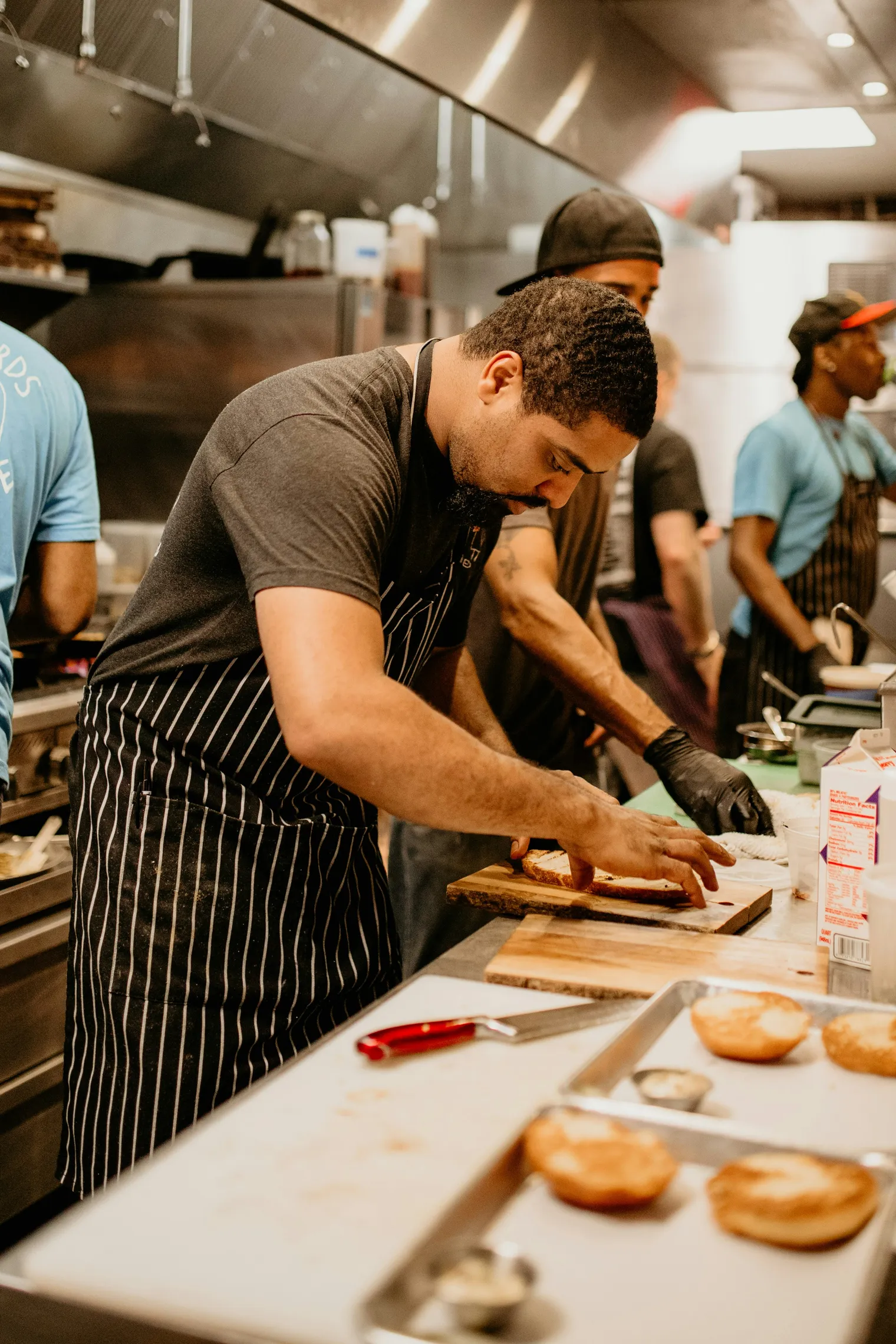 A group of kitchen staff working together preparing food